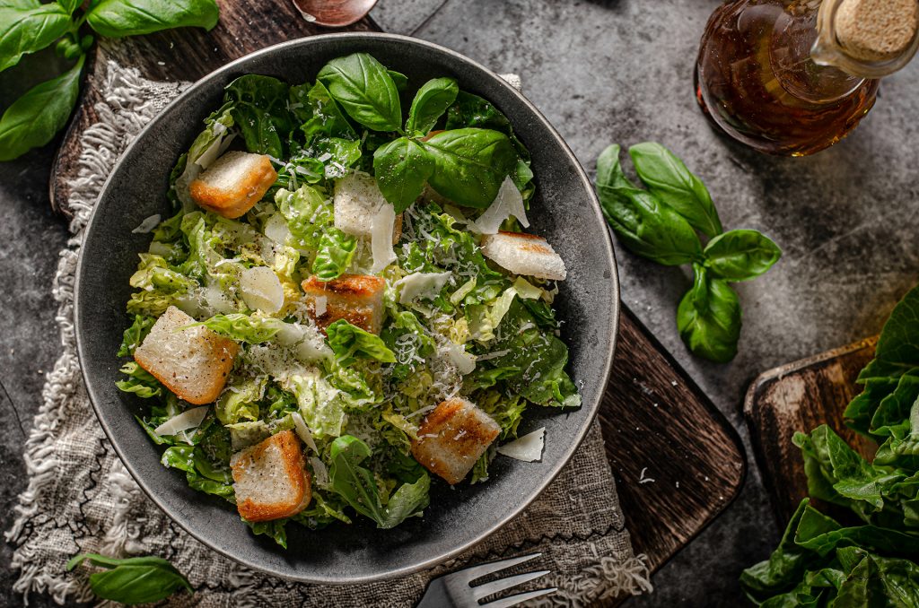 Caesar salad with croutons and fresh basil