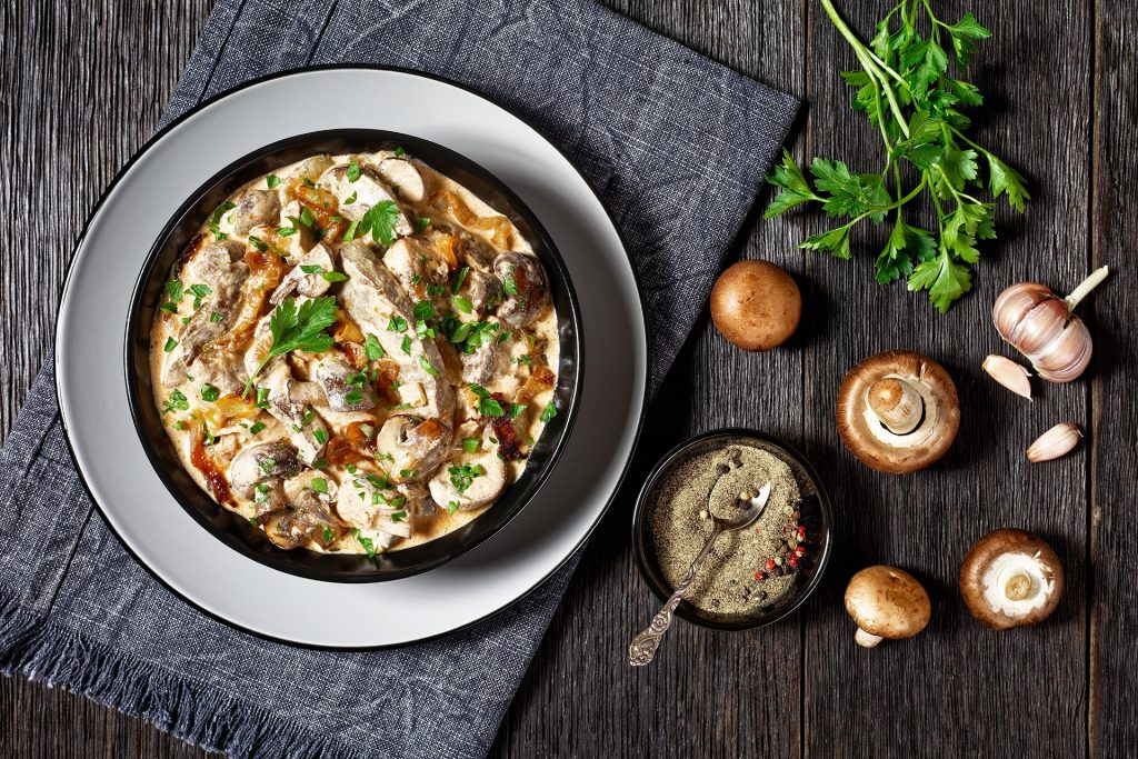 Creamy mushroom dish in a bowl with fresh herbs